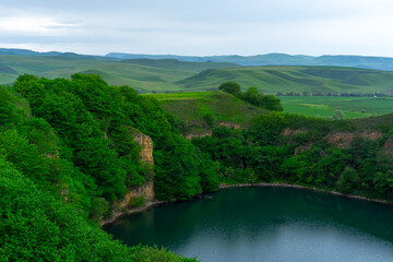 Fototapeta na wymiar Mountain lake surrounded by vegetation