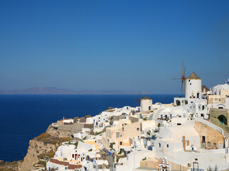 Beautiful village of Oia on the island of Santorini, Greece, white buildings, blue sky, terraced cliffs