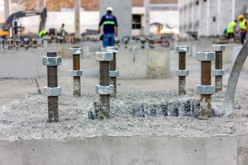 View of the anchor bolts for fondation in the concrete. An anchor bolt is a fastener used to attach...