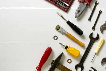 Layout of repair and construction tools on a white wooden background. Space for text