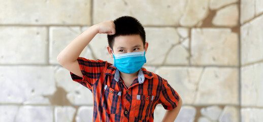 Obraz premium Portrait boy face wearing medical face mask, at home during covid-19 lock down.