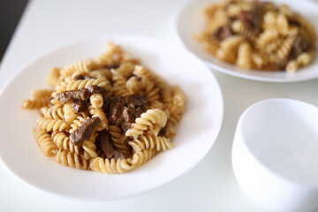 Spaghetti with meat and spices on plate. Food stylism concept