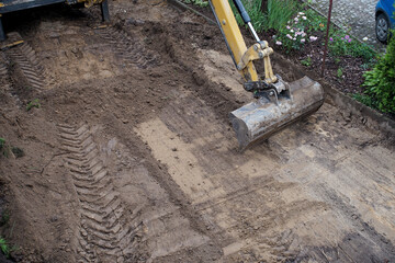 leveling the ground by an excavator on the construction site