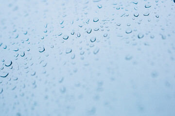Raindrops on window glass,condensation on the window,natural background,color texture,blue abstract and pattern
