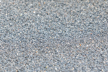 Background of sand (basalt) grits for sandblasting or abrasive blasting of metal surfaces.