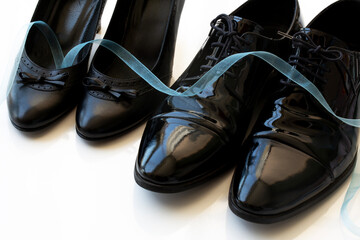 Black man and woman patent leather shoes on white background. Copy space for text. Wedding. Divorce. Honeymoon.