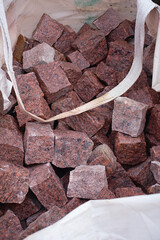 red, granite cobblestones in a transport bag