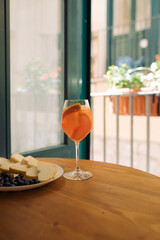 Summer Refreshing Aperitif Drink Aperol on the balcony table. Fresh summer cocktail. Home relaxation concept.