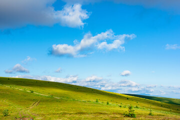 wonderful mountain landscape in summer. beauty of nature in green and blue. meadows on rolling hills of the rindge. wonderful weather in warm light. blue sky with puffy clouds