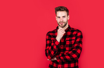 handsome man wear checkered shirt. unshaven guy in casual style. male hairdresser and barbershop. male beauty trend. bearded man with sexy bristle. facial hair and skin care. copy space