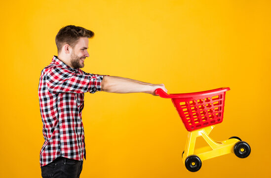 Weekend On Buying Products. Rejoices Successful Purchases. Spends Money Unwisely. Customer Pushing Cart. Buyer In Supermarket. Empty Toy Trolley. Man Go Shopping. Funny Man With Small Shopping Cart