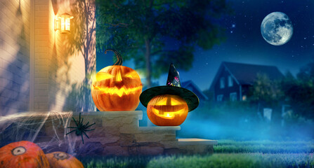 Jack O’ Lanterns glowing at moonlight in night. Spooky pumpkin in witch hat. Halloween design...