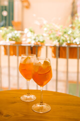 Glasses of Aperitif drink on the balcony table. Fresh summer cocktail. Home relaxation concept.