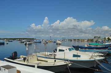 Fototapeta premium Boats in the small bay of Porto Cesareo, in the Puglia region.
