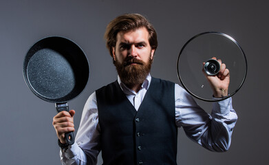 businessman with skillet. bearded man in suit hold pan. man cooking in kitchen. presenting quality...