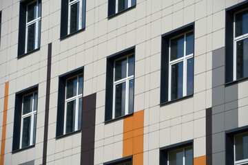 facade of a modern building on a bright Sunny day, siding and Windows, beautiful exterior of the new building