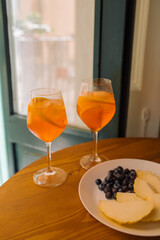 Glasses of Aperitif drink on the balcony table. Fresh summer cocktail. Home relaxation concept.