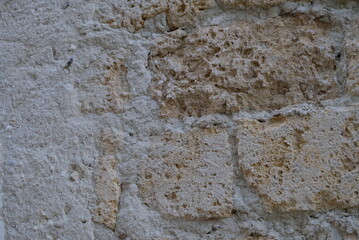 Old white brick wall with cracked plaster and black mold. Texture, background of old white brick wall with cracked plaster and black mold