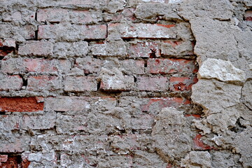 Old white brick wall with cracked plaster and black mold. Texture, background of old white brick wall with cracked plaster and black mold