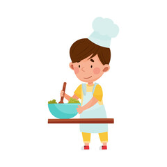 Cute Boy Character in Hat and Apron Standing at Kitchen Table and Stirring Salad Vector Illustration