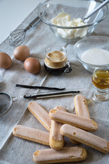 Ingredients for homemade tiramisu: mascarpone cheese, eggs, coffee, vanilla, sugar, cocoa powder and ladyfingers. 