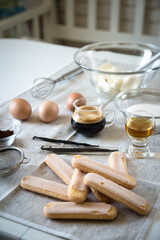Ingredients for homemade tiramisu: mascarpone cheese, eggs, coffee, vanilla, sugar, cocoa powder and ladyfingers. 