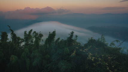 From Tiger Hill in Darjeeling to the Himalayan mountain range before sunrise the mountains are covered in clouds, the colors of nature are beautifully divided into layers.