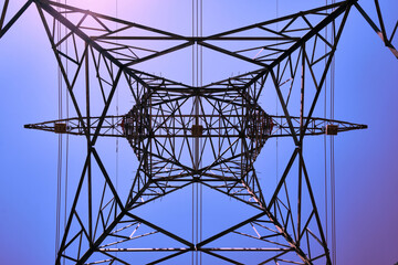 Power line metal pylon with high voltage cables bottom up view