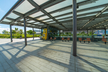A rest stop in a park in the heart of a modern city.