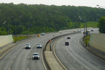 Modern multi-lane motorway with driving cars.