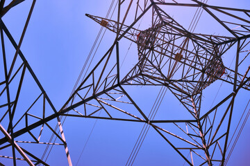 Power line metal pylon with high voltage cables bottom up view