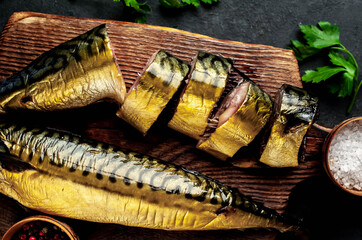 
Smoked mackerel on a cutting board on a stone background