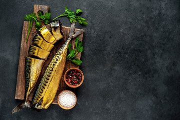 
Smoked mackerel on a cutting board on a stone background 
with copy space for your text