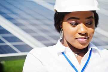 African american technician check the maintenance of the solar panels. Black woman engineer at solar station.