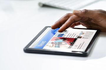 African Woman Looking At News In Online Newspaper