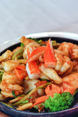 seafood stir-fried with fresh vegetables in a hot pan