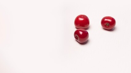 Naklejka na ściany i meble red ripe cherry on a white background. Macro cherry, space for text. Recipe blank