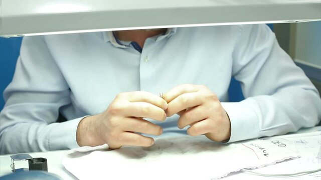 The gemologist checking the diamonds carat and quality diamond ring