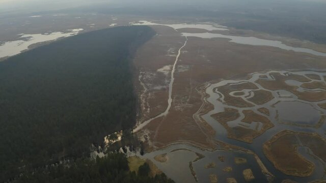 Aerial panning of rare Engure lake geometric islands and fog
