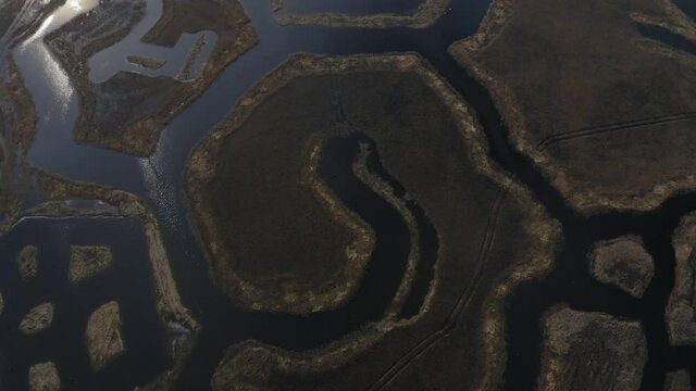Aerial foward shot of weird geometric figures in Engures lake