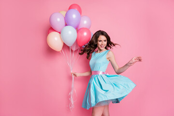 Photo of positive cheerful girl hold many air balloons enjoy anniversary party celebration wear good look clothes isolated over pastel color background