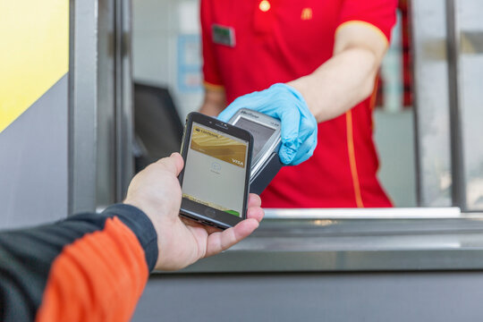 Moscow, Russia, 30/05/2020: Payment For The Order By Phone From McDonald's From The Car Window. Close-up. Drive Thru.