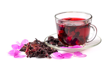 Hibiscus tea in glass cup among the rose petals and dry petals isolated on white background.