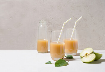 Healthy food concept. Juice from apples and kiwi with pulp in a glass.
