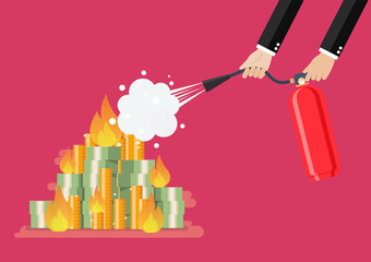 Businessman with fire extinguisher is fighting with the burning money