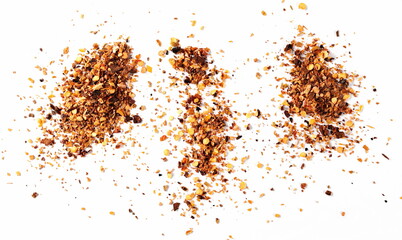 Spicy chili pepper flakes, crushed, milled dry red paprika pile isolated on white background, top view