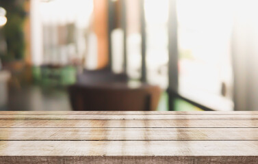 Fototapeta na wymiar Wooden top table with bokeh light effect and blur restaurant on background, blur background