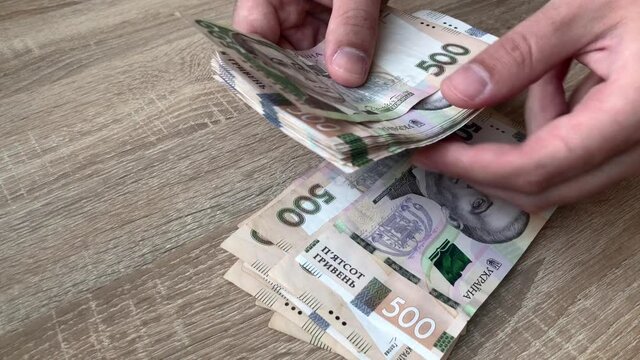 Close-up Of A Man's Hand Counting Large Amounts Of Money Manually In Cash For The Purchase Of Bitcoin Cryptocurrency. Counting Banknotes Of 100 American Dollars And 50.10, 5 Euros. 4K.