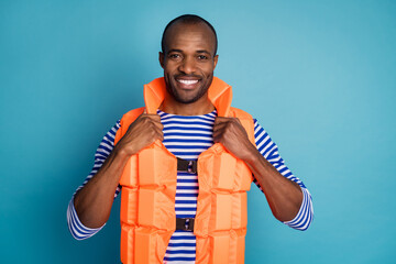 Close-up portrait of his he nice attractive cheerful cheery content guy sailor instructor wearing safety vest lifesaver isolated over bright vivid shine vibrant blue color background