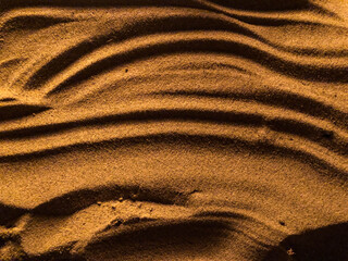 Drawing in the sand. Evening under the light of fire